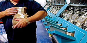Man working in a cash processing centre.