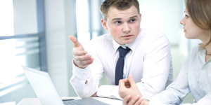 People discussing next to a computer